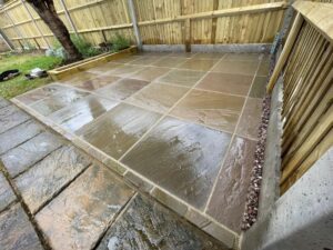 New featherboard fence and sandstone patio installed in Hazlemere